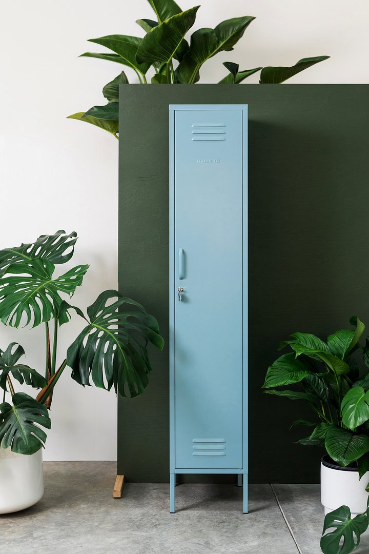 Mustard Made The Skinny Locker in ocean blue with plants surrounding it