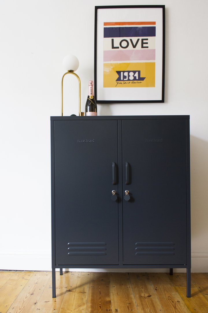 Mustard Made The Midi Locker in slate with a posted above and a lamp sitting on top