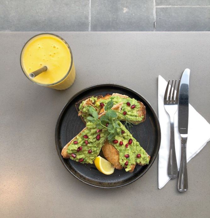 plate of avocado on toast, cutlery and a smoothies from little bird cafe in Perth, Scotland