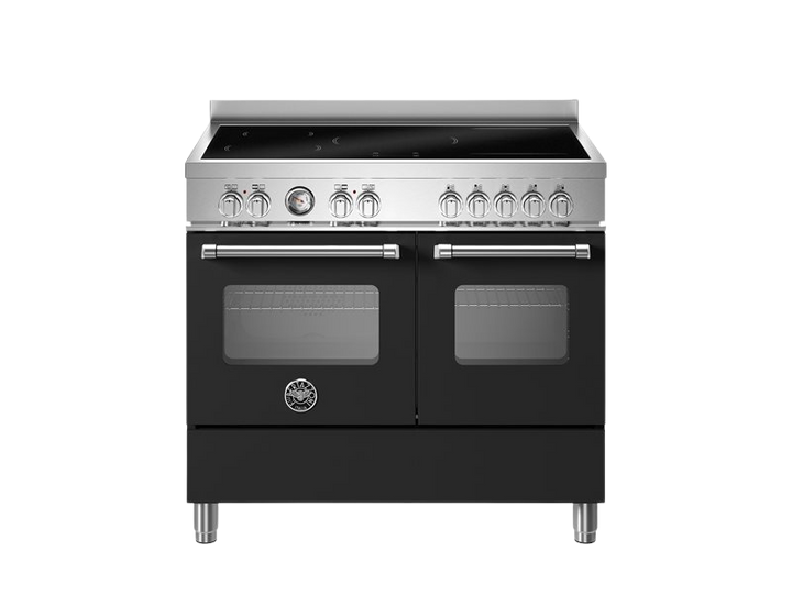 Stainless steel kitchen stove with black panels on a white background