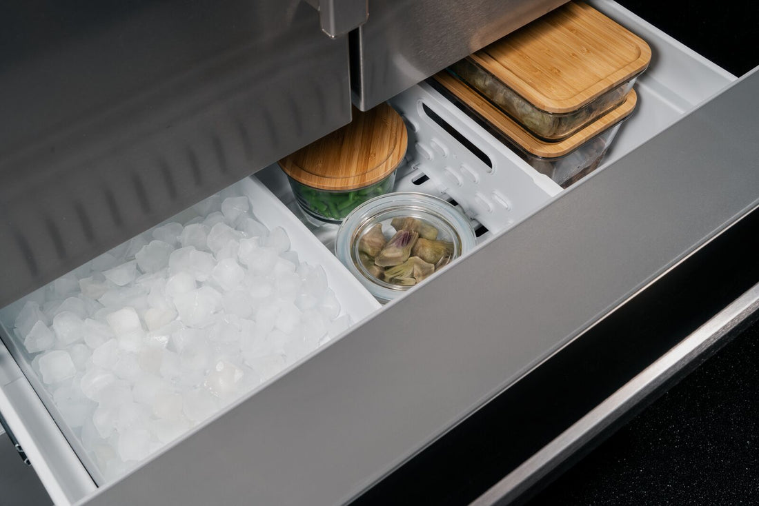 bertazzoni 90cm french door freezer open with ice maker on the left side and food in the other freezer drawers