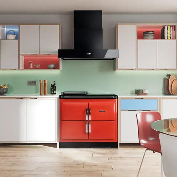 Rayburn tomato red range cooker in a modenr looking kitchen with white cabinets and a black extractor