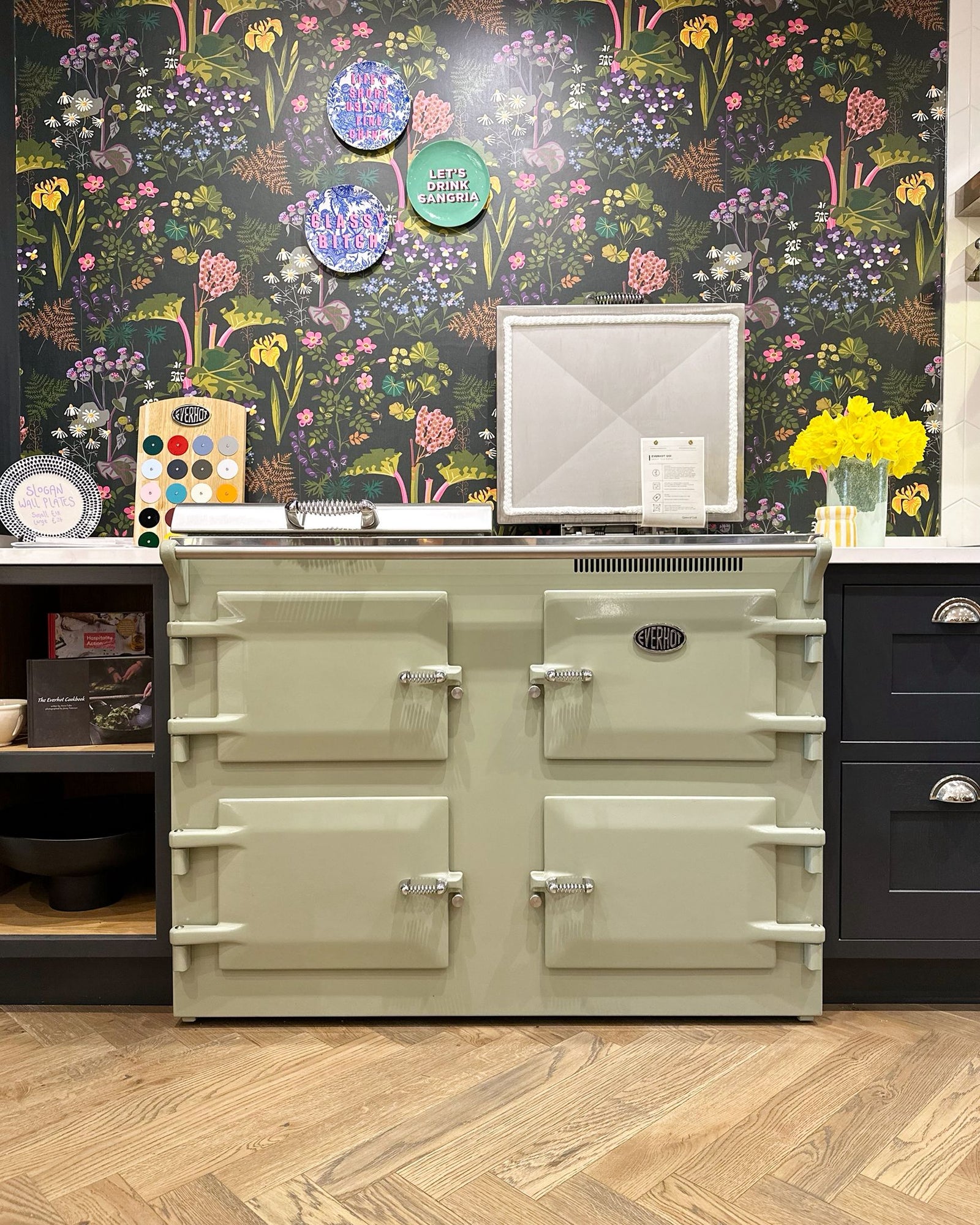 Green range cooker installed beneath a kitchen extractor hood
