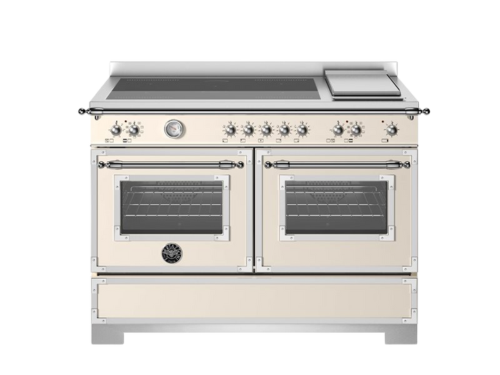 Stainless steel kitchen range with dual ovens on a white background