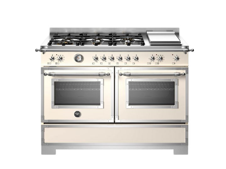 Stainless steel kitchen range with dual ovens on a white background