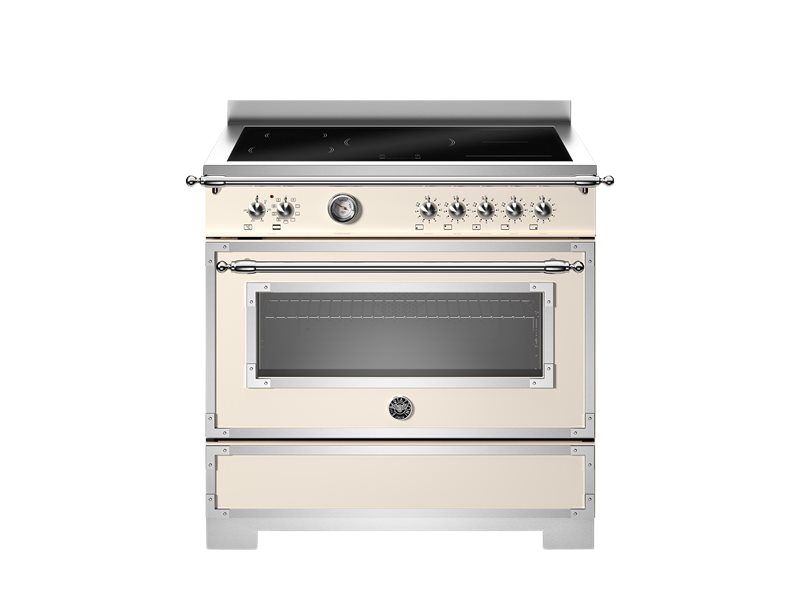 Stainless steel and cream-colored kitchen stove on a white background