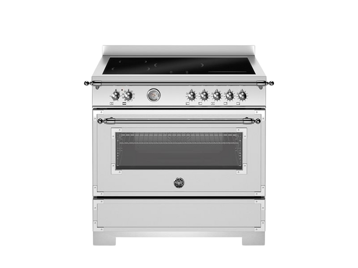 White kitchen stove with black cooktop on a white background