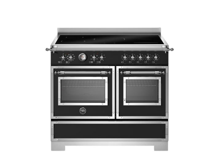 Stainless steel kitchen range with dual ovens on a white background