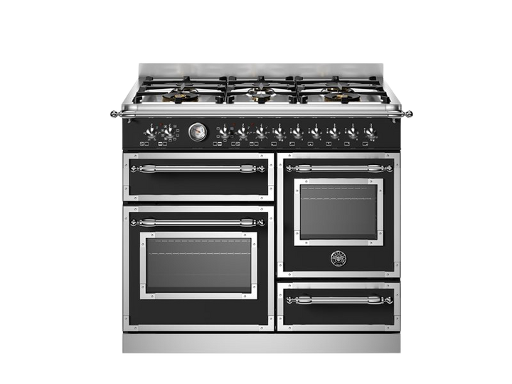 Stainless steel kitchen range with gas cooktop on a white background