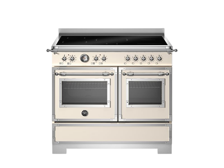 Stainless steel and cream-colored kitchen range with dual ovens on a white background