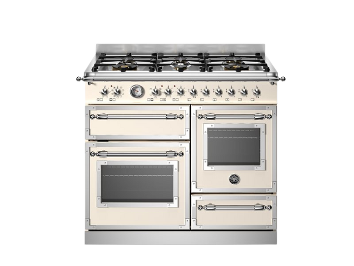 Stainless steel and cream-colored kitchen range with gas cooktop on a white background