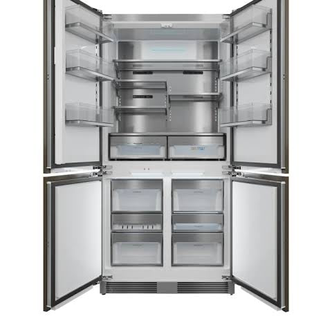 A side-by-side refrigerator with all four doors open, showing the stainless steel interior with shelves, door bins, and lower drawer compartments against a white background.