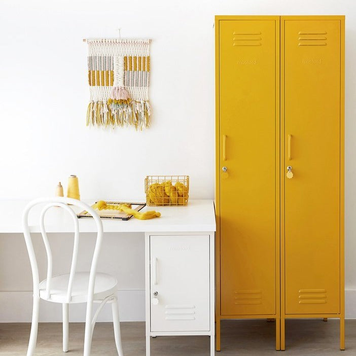 Mustard Made The Skinny Locker two side by side in mustard beside a white desk with a shorty mustard made underneath