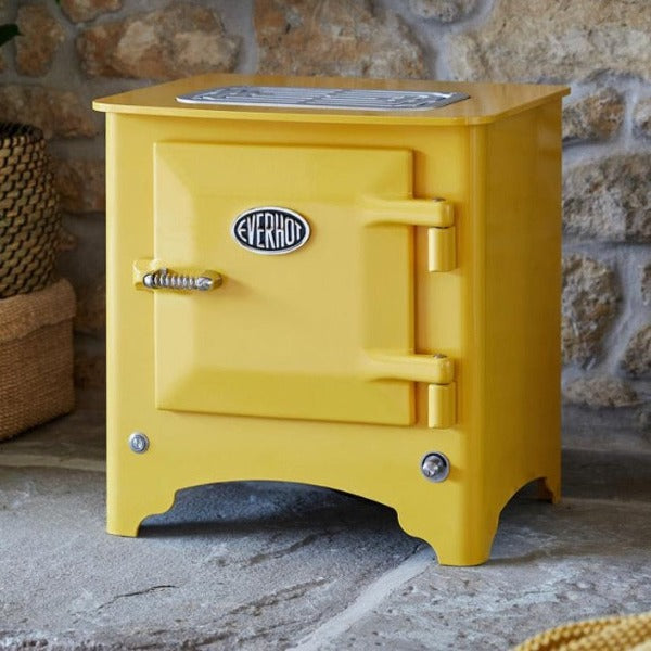 Everhot Electric Stove in Mustard infront of exposed stone brick wall