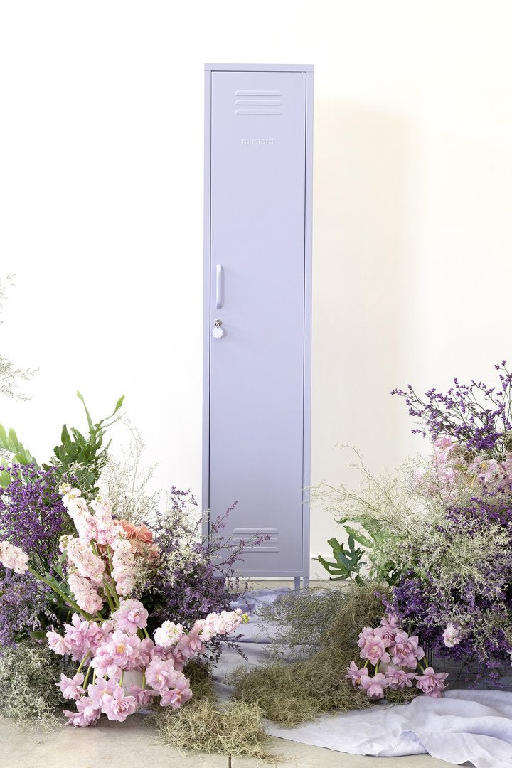 Mustard Made The Skinny Locker in lilac surrounded by flowers of a similar colour 