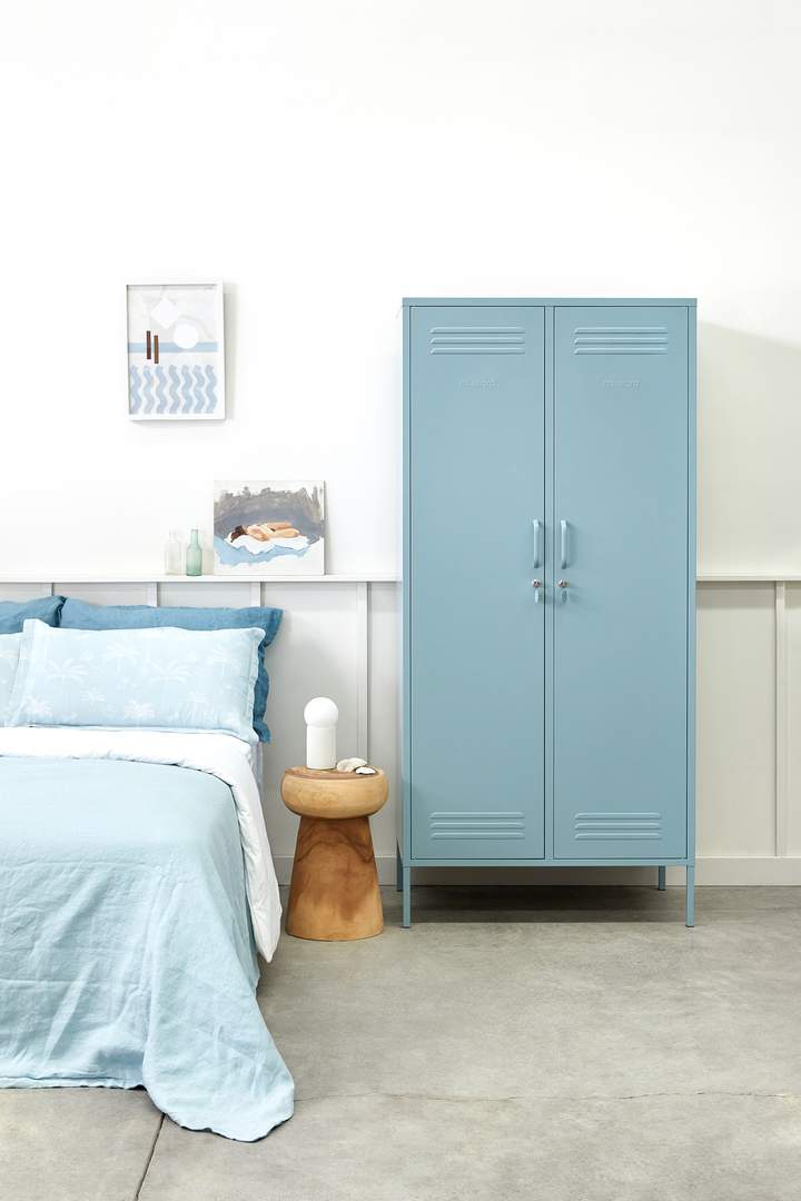 Mustard Made The Twinny Locker in light blue beside a light blue bed 