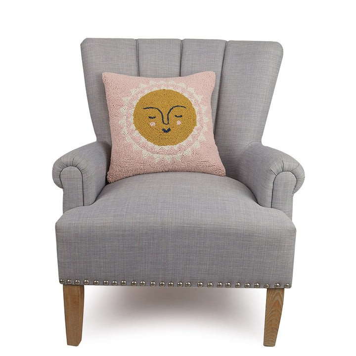 Sun wool pillow on gray armchair 
